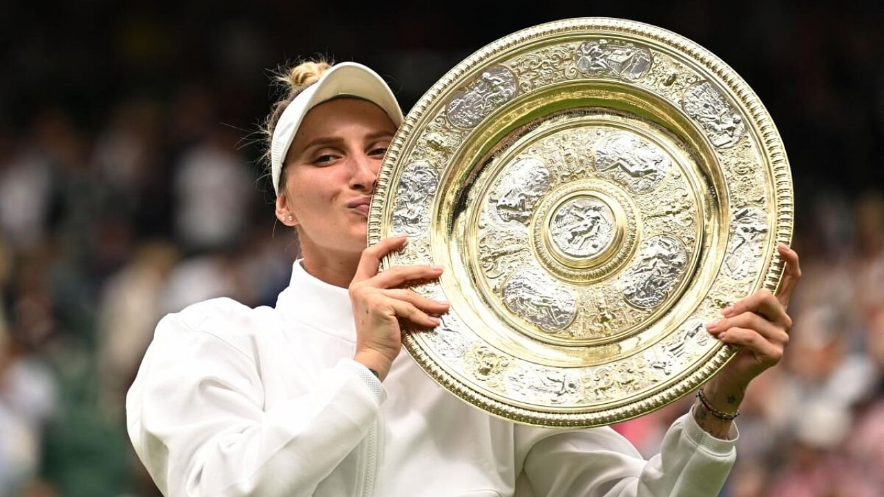 Czech Republic's Marketa Vondrousova celebrates with the trophy winning her final match against Tunisia’s Ons Jabeur. Credit: Reuters Photo