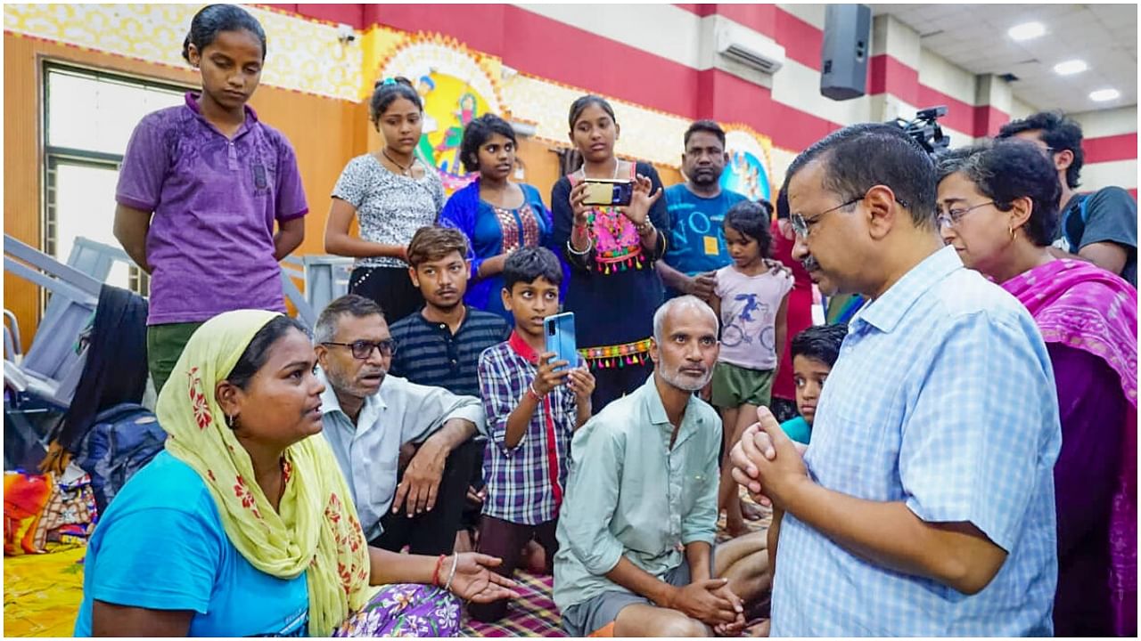 Delhi Chief Minister Arvind Kejriwal interacts with people at a flood relief camp following monsoon rains, at Mori Gate in New Delhi, Sunday, July 16, 2023. Credit: Twitter/@AamAadmiParty