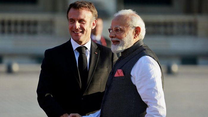 French President Emmanuel Macron and Indian Prime Minister Narendra Modi shake hands ahead of a dinner held at the Louvre in Paris. Credit: Reuters File Photo