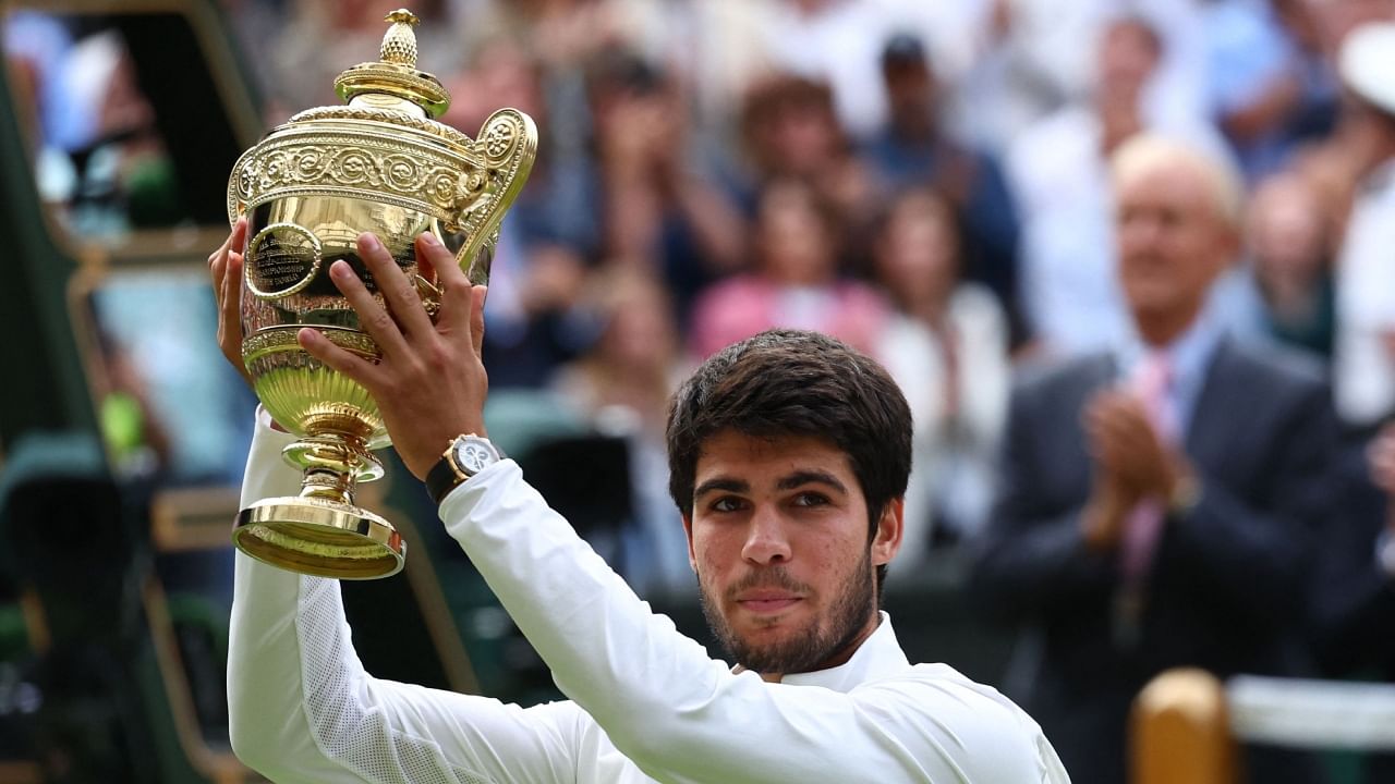 Spain's Carlos Alcaraz celebrates with the trophy after winning his final match against Serbia's Novak Djokovic. Credit: Reuters Photo