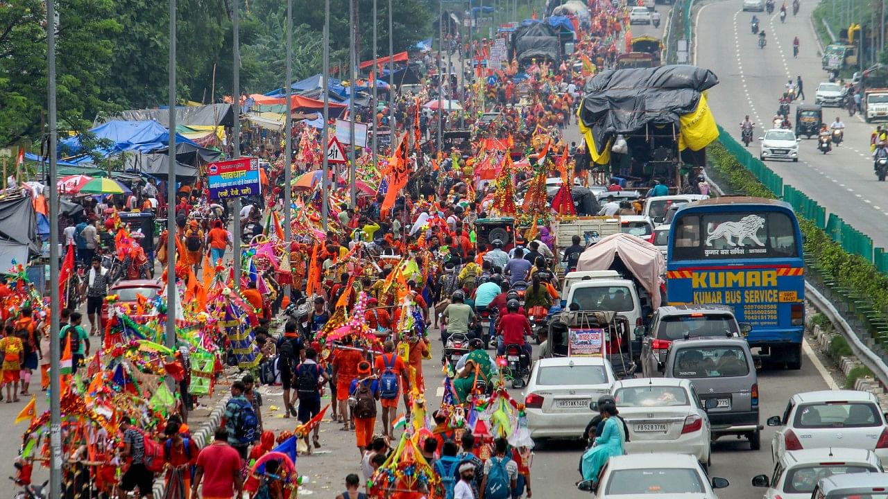 <div class="paragraphs"><p>Lord Shiva devotees or 'Kanwariyas' carrying holy water from the Ganga river during their pilgrimage. </p></div>