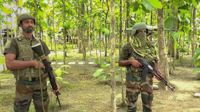 Personnel of Assam Rifles keep a watch amid ongoing ethnic clashes in the state, at Phaileng village in Senapati district. Credit: PTI File Photo