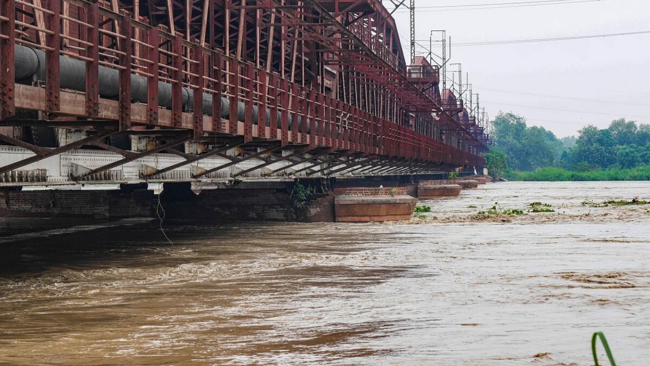 The swollen Yamuna river flows under Old Yamuna Bridge. Credit: PTI Photo