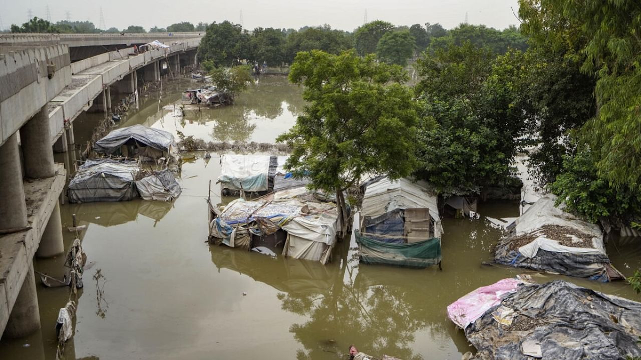 Houses submerged in the floodwaters of the swollen Yamuna river. Credit: PTI Photo