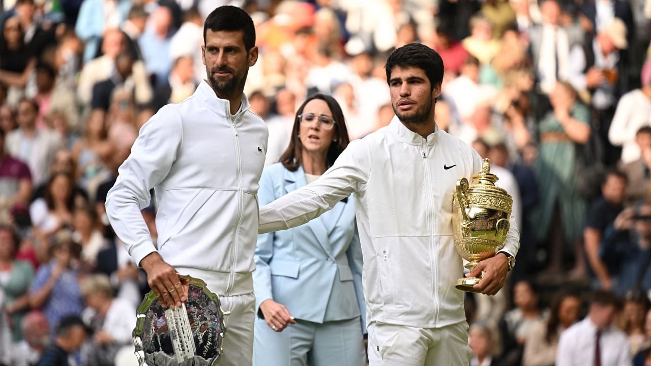 Spain's Carlos Alcaraz poses with the trophy after winning his final match alongside runner-up Serbia's Novak Djokovic. Credit: Reuters Photo