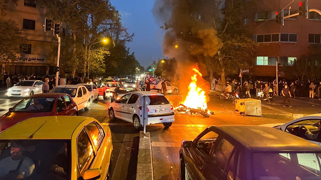 A police motorcycle burns during a protest over the death of Mahsa Amini, who died after being arrested by the Islamic republic's "morality police", in Tehran, Iran September 19, 2022. Credit: WANA (West Asia News Agency) via Reuters Photo