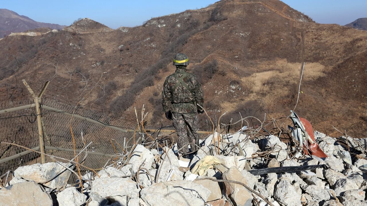 A South Korean army soldier stands guard at the South's dismantled guard post inside the Demilitarized Zone (DMZ) in the central section of the inter-Korean border in Cheorwon, December 12, 2018. Credit: Ahn Young-joon/Pool via Reuters Photo