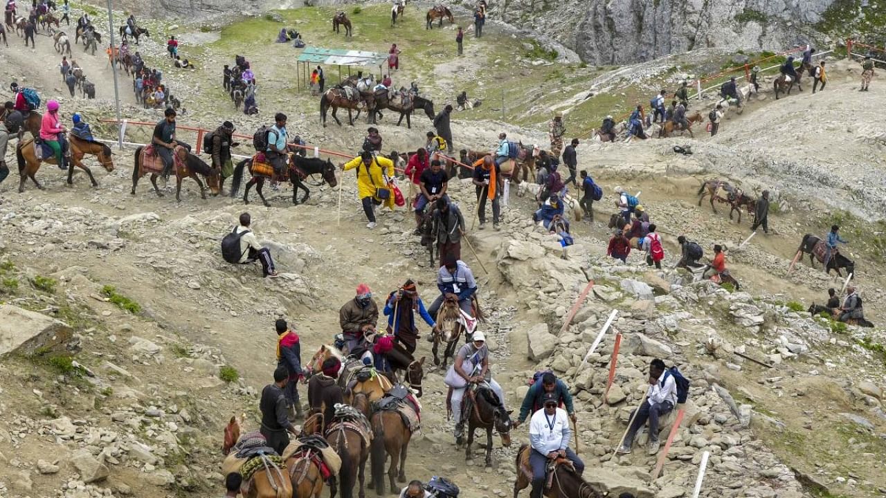 Devotees during the pilgrimage to the holy cave shrine of Amarnath, in Jammu and Kashmir, Friday, July 14, 2023. Credit: PTI Photo