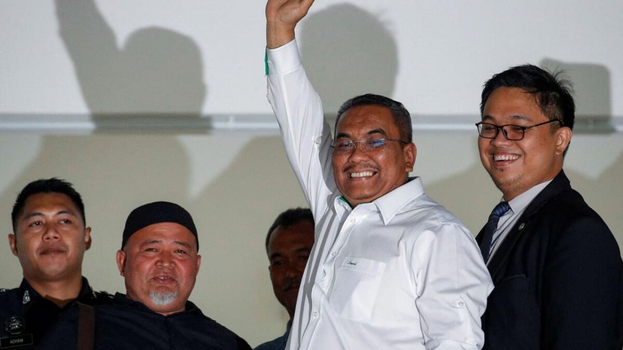 Malaysia's opposition leader Muhammad Sanusi Md Nor waves to the media as he leaves a court where he was charged in Gombak, Malaysia. Credit: Reuters Photo