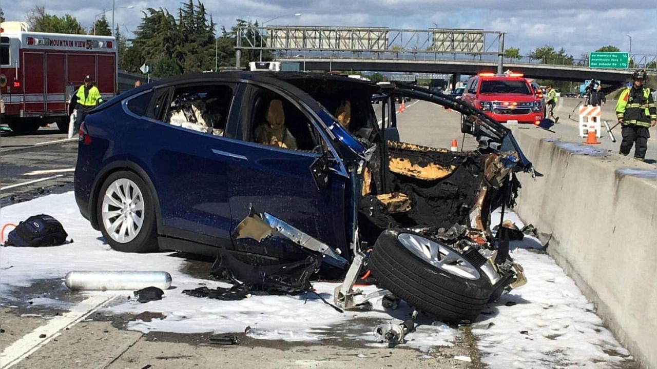 File photo of rescue workers at a Tesla electric SUV crash site in California. Photo Credit: Reuters File Photo