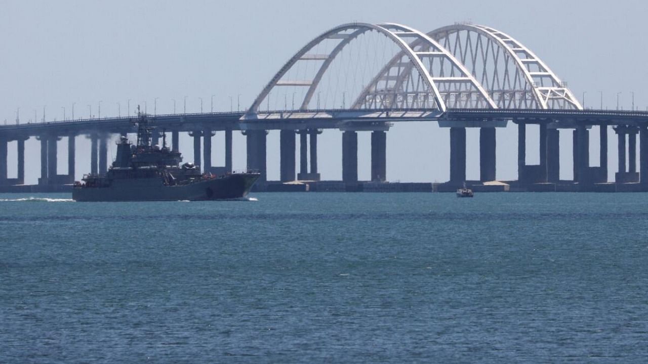 A Russian Navy amphibious landing ship that was deployed to transport cars across the Kerch Strait moves near the Crimean Bridge. Credit: Reuters Photo