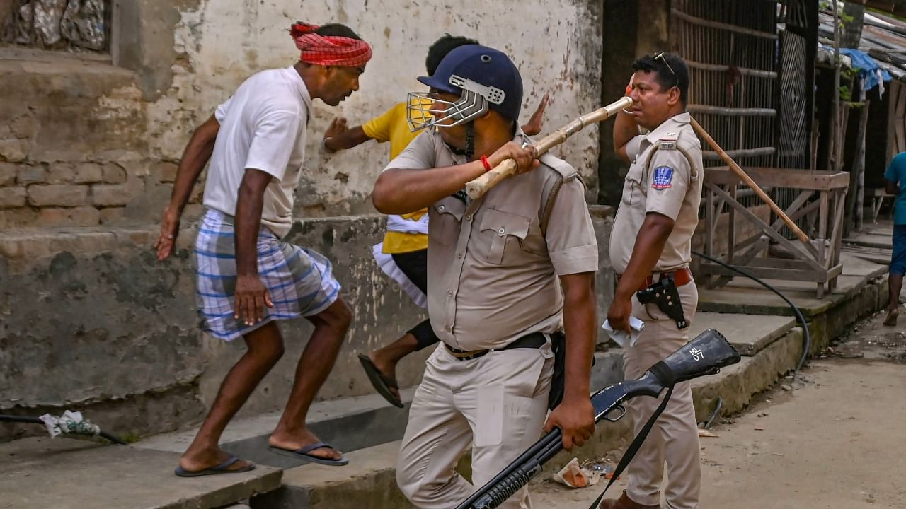 Police personnel baton charge after a clash between rival political groups during panchyat elections, at Nagaria village in Malda district of West Bengal. Credit: PTI File Photo