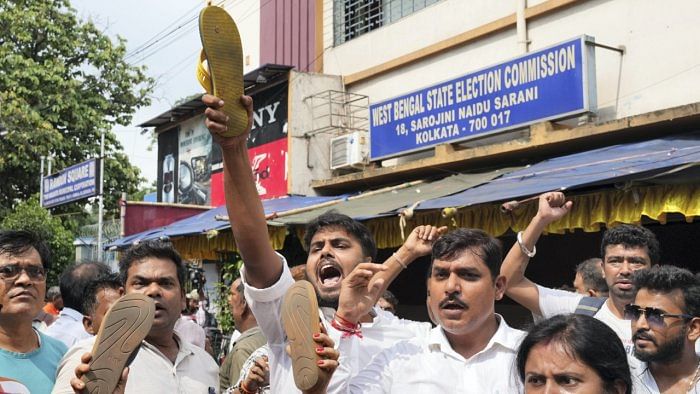 BJP workers hold slippers during their agitation outside West Bengal State Election Commission office to protest against the violence during West Bengal panchayat elections, in Kolkata, Sunday, July 9, 2023. Credit: PTI File Photo