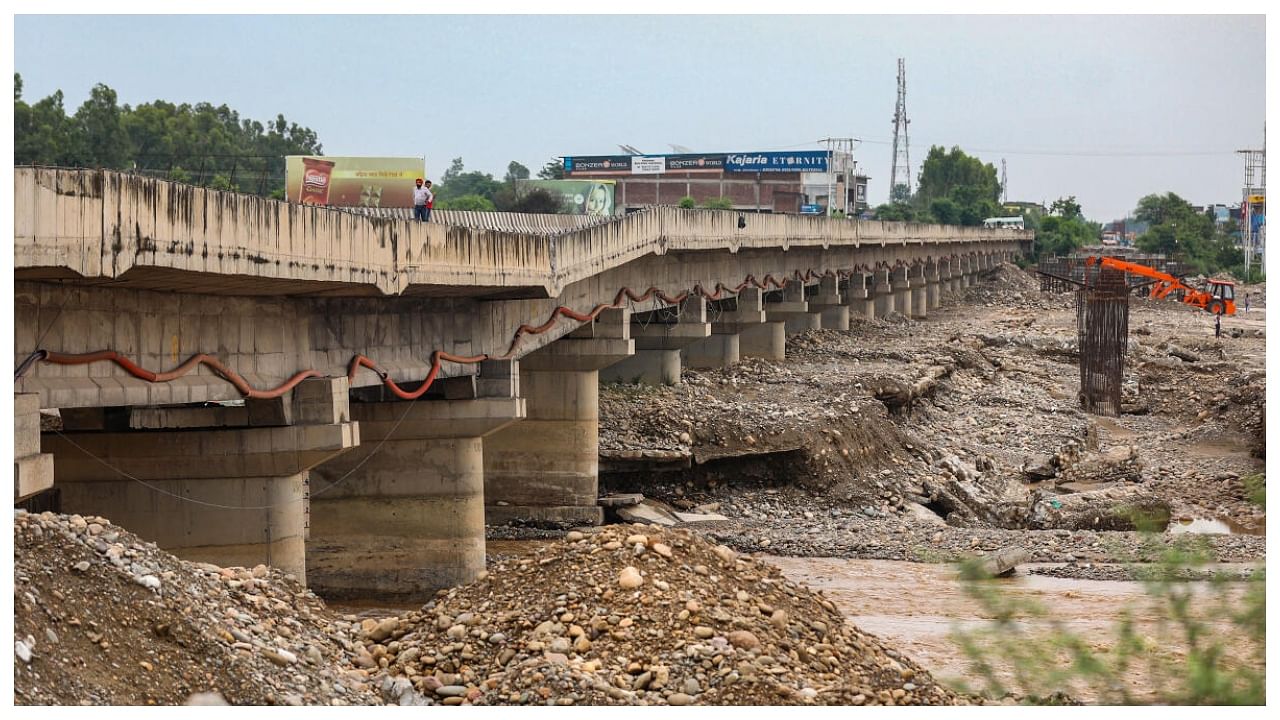 A bridge on the Jammu-Pathankot highway suffers damages due to flash floods in Tarnah Nallah, about 85 km from Jammu, in Kathua district, Wednesday, July 19, 2023. Credit: PTI Photo