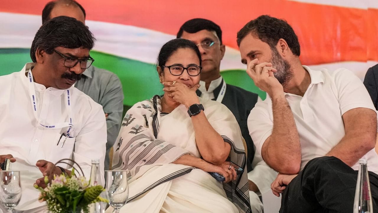 Congress leader Rahul Gandhi (R), Bengal CM Mamata Banerjee (M) and Jharkhand CM Hemant Soren (L) at a joint press conference after Opposition meet, in Bengaluru, Tuesday. Credit: PTI Photo