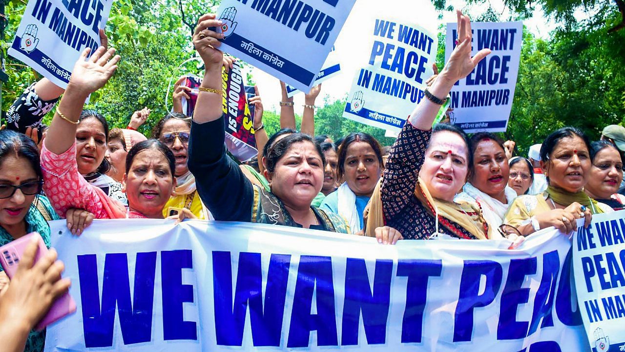 Mahila Congress President Netta D'Souza with workers raises slogans during a protest over Manipur violence, in New Delhi. Credit: PTI Photo