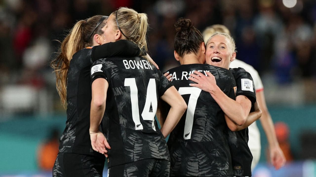 New Zealand's Betsy Hassett, Katie Bowen and Ali Riley celebrate after the match. Credit: Reuters Photo