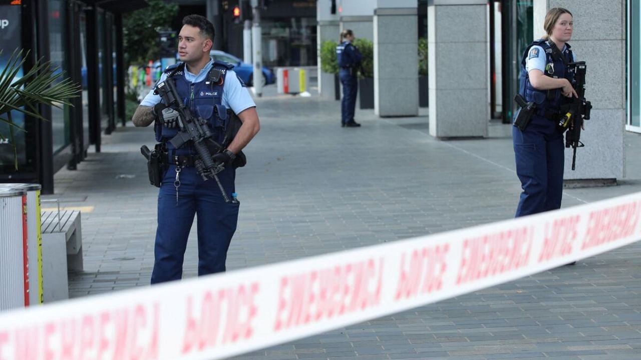 Police officers stand guard near the location of a reported shooting in Auckland, New Zealand on July 20, 2023. Credit: Reuters Photo