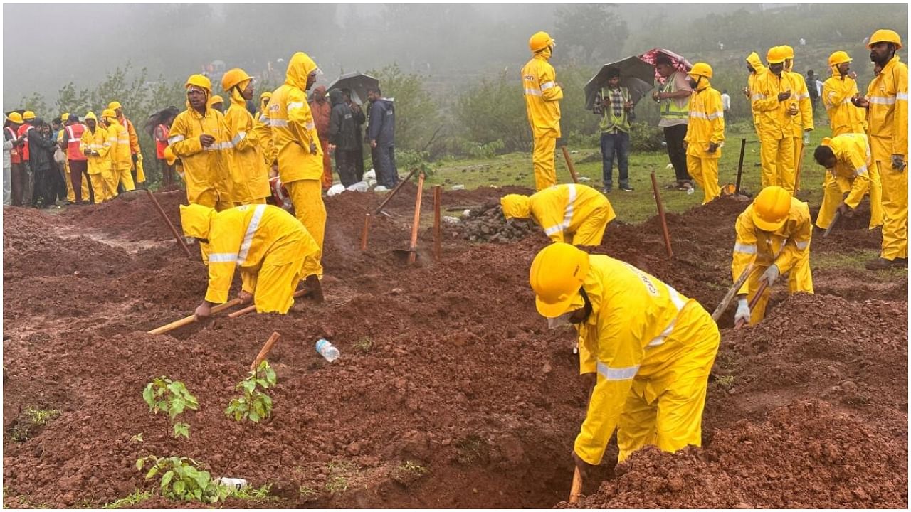 Members of rescue teams prepare graves to bury the victims after a landslide following heavy rains in Raigad district in the western state of Maharashtra, India, July 20, 2023. Credit: Reuters Photo