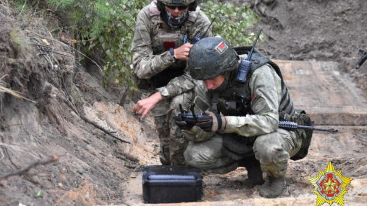 A fighter from Russian Wagner mercenary group and a Belarusian service member take part in a joint training outside Brest. Credit: Belarusian Defence Ministry/Handout via Reuters