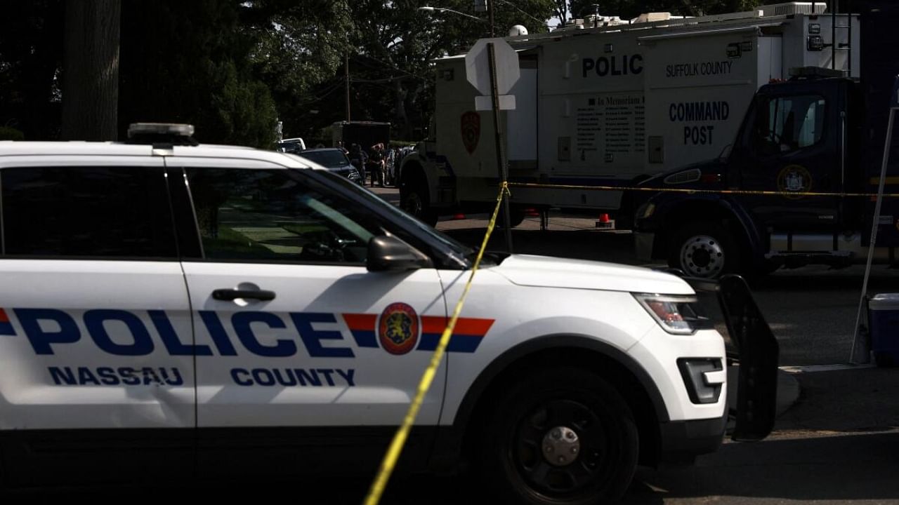 Crime scene investigators walk outside the residence of architect Rex A. Heuermann, who was detained as a suspect in connection with serial killings more than a decade ago, that targeted sex workers and others, whose bodies were strewn along Gilgo beach, in Massapequa Park, New York, US, July 20, 2023. Credit: Reuters Photo