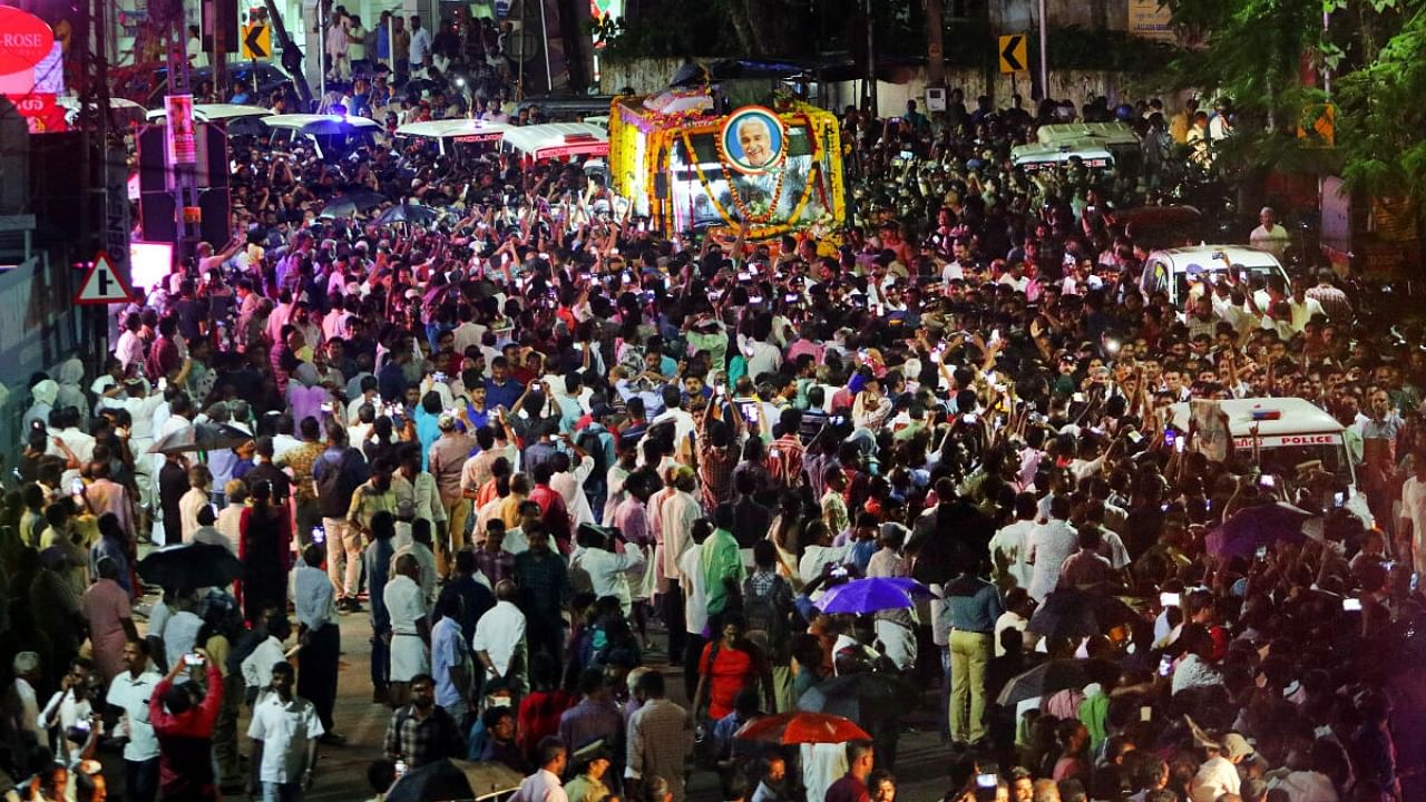 Crowds gather as the mortal remains of former Kerala Chief Minister Oommen Chandy being taken to Kottayam from Thiruvananthapuram, Wednesday, July 19, 2023. Credit: PTI File Photo