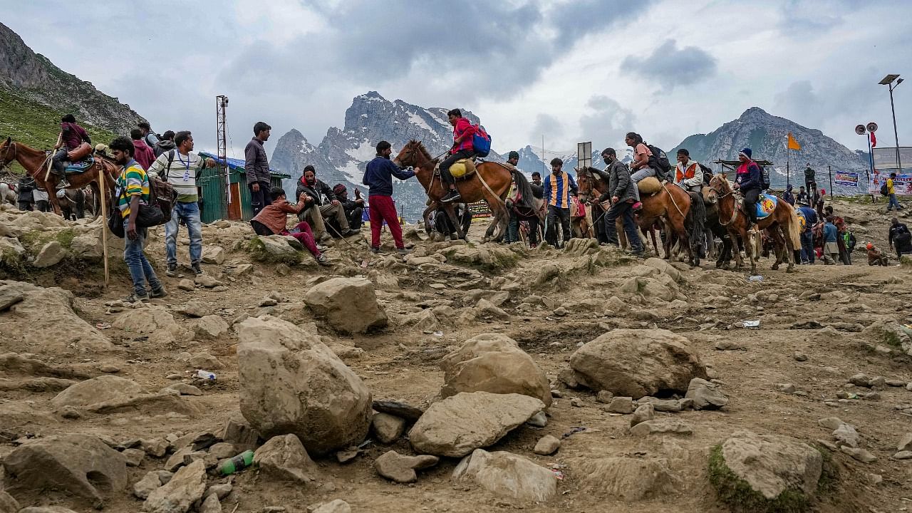 Ponies carry pilgrims at the Pissu Top during Amarnath Yatra 2023, in Amarnath. Credit: PTI Photo