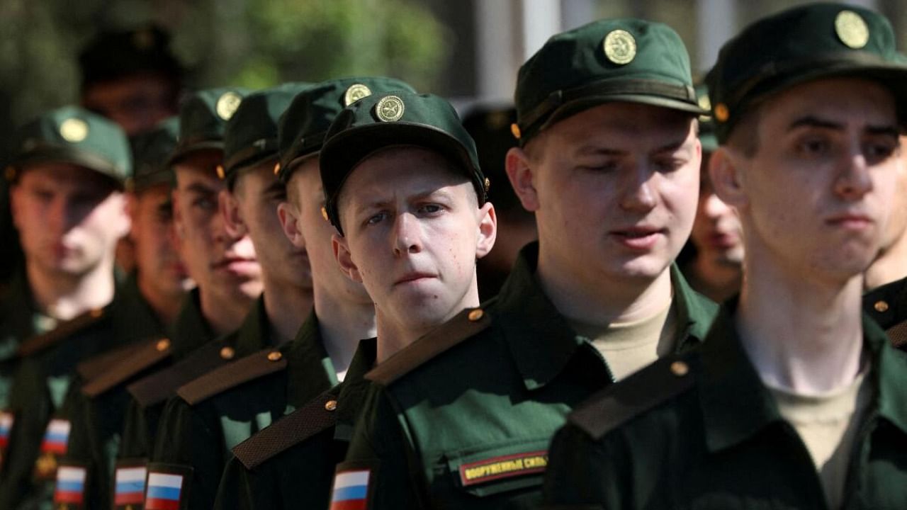 Russian conscripts called up for military service line up before their departure for garrisons as they gather at a recruitment centre in Simferopol, Crimea, April 25, 2023. Credit: Reuters Photo