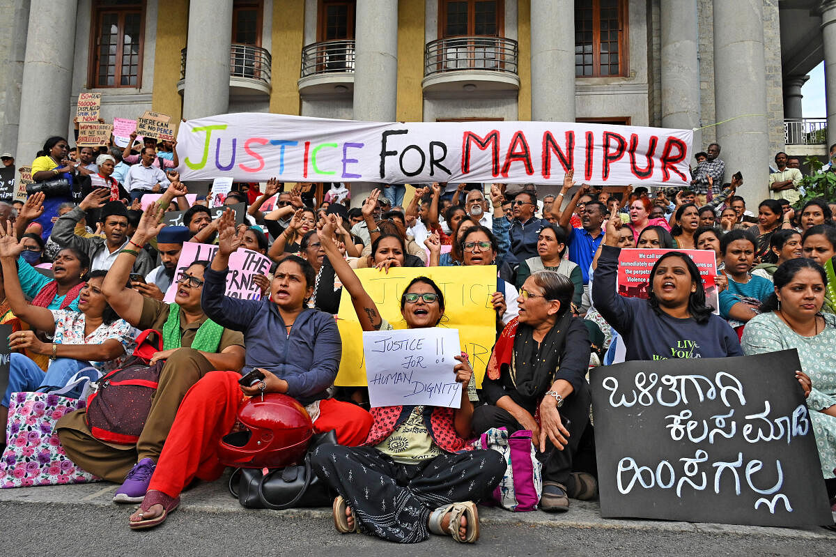 Members of various organisations and citizens hold placards during the protest at Town Hall on Friday. Credit: DH Photo/Pushkar V