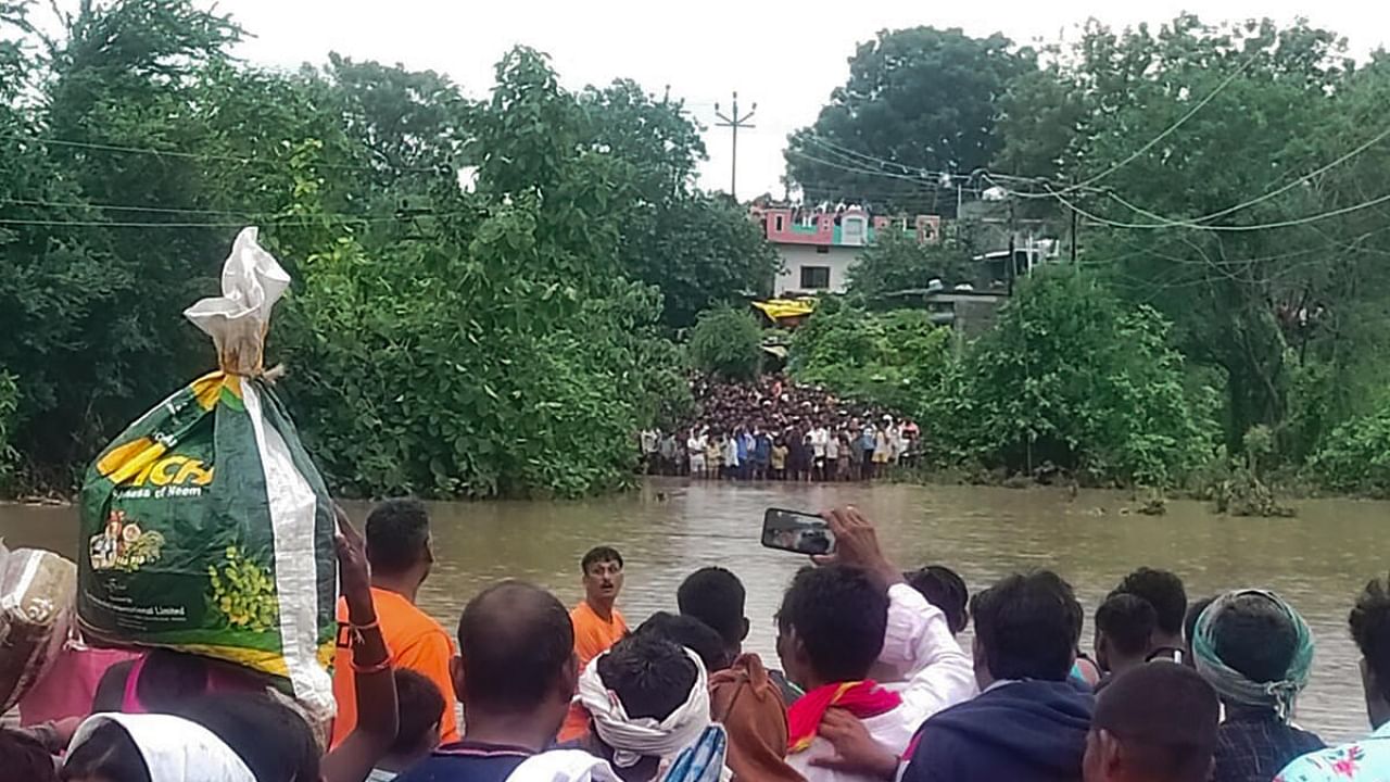 SDRF teams rescue the stranded people after a cloudburst during monsoon, in Yavatmal district, Saturday, July 22, 2023. PTI Photo