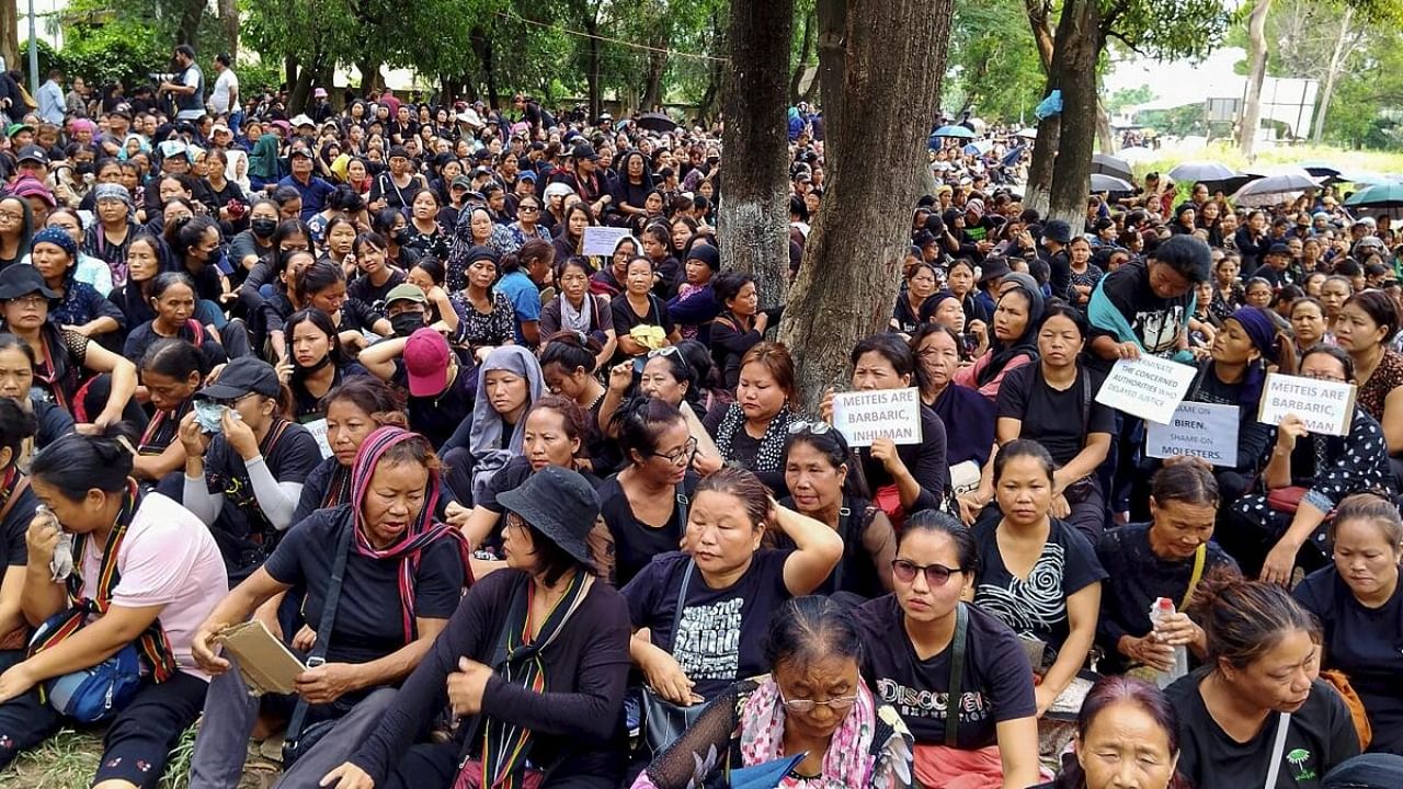 Women's wing of the Indigenous Tribal Leaders' Forum (ITLF) stage a protest near the 'Wall of Remembrance' erected to honor lives lost during the ongoing ethnic violence in the state, in Churachandpur, Saturday, July 22, 2023. Credit: PTI Photo