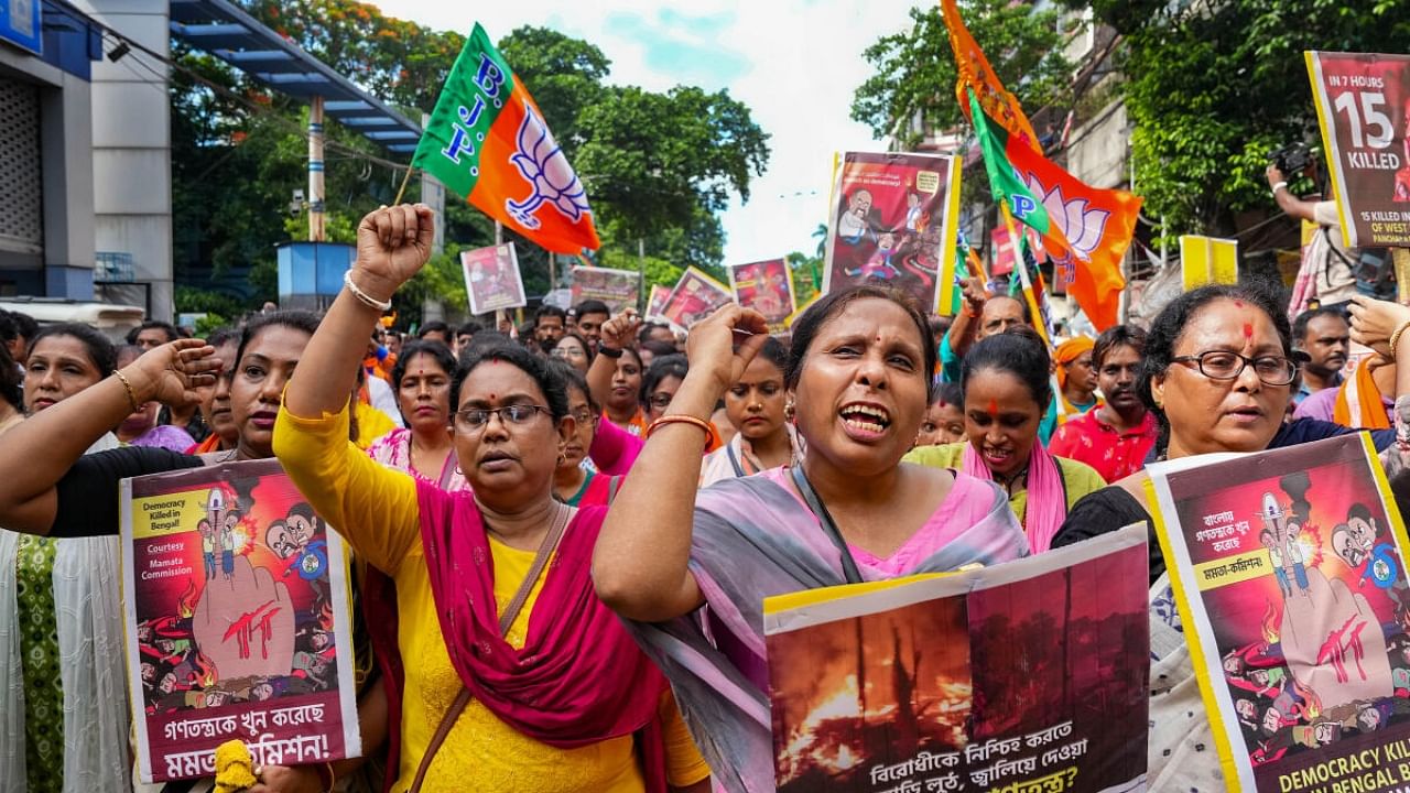 BJP activists shout slogans during a protest rally over alleged violence in recent Panchayat polls, in Kolkata. Credit: PTI Photo