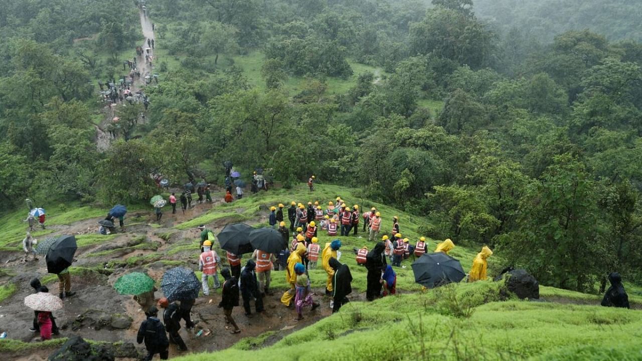 National Disaster Response Force (NDRF) personnel and other volunteers at the site of a landslide at a village in Raigad. Credit: Reuters Photo