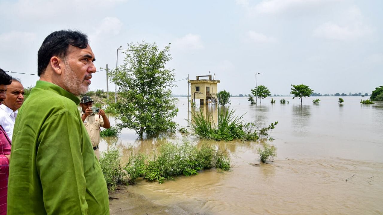 Delhi Environment Minister Gopal Rai inspects the swollen Yamuna river. Credit: PTI Photo