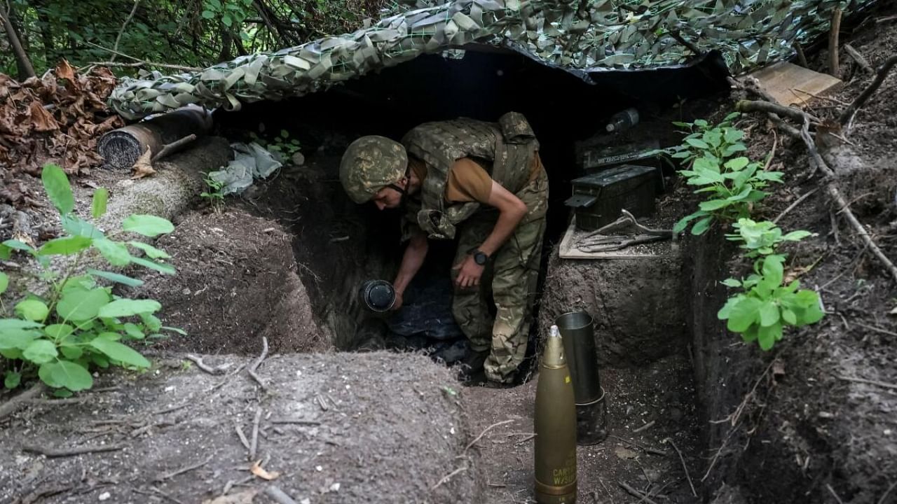 A Ukrainian serviceman rests at a front line. Credit: Reuters Photo
