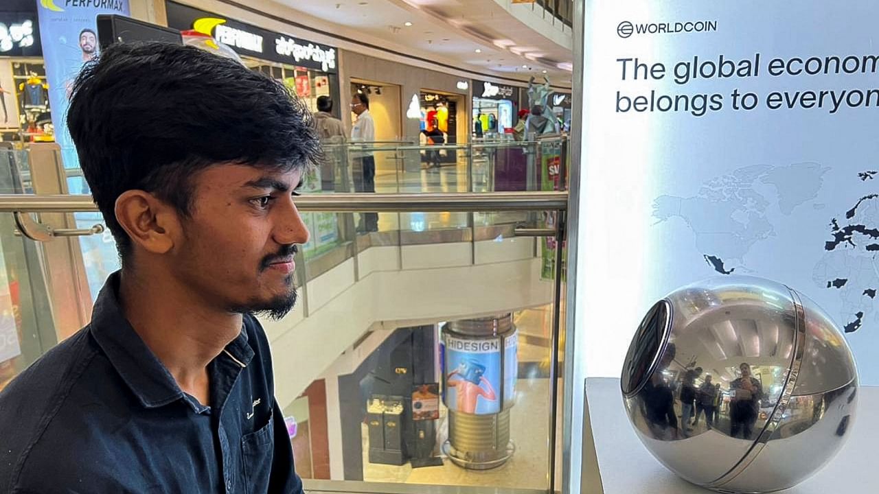 Kaleem, 22, an engineer in Bengaluru, signs up for WorldCoin by having his eyes scanned by the spherical device in Mantri Square Mall in Bengaluru, India July 25, 2023. Credit: Reuters Photo