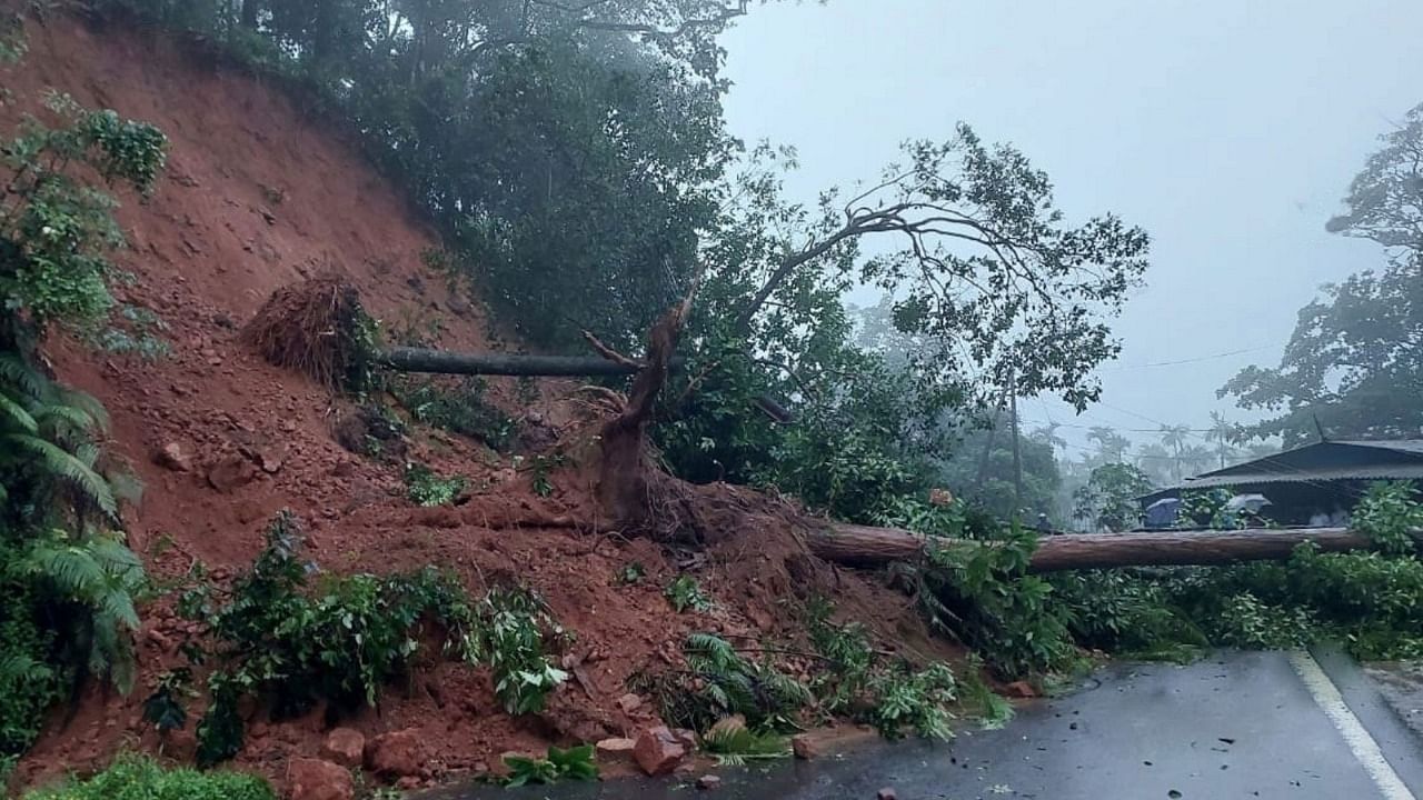 Landslides on Madikeri-Mangaluru road at Karthoji in Madenadu affected the movement of vehicles. Credit: DH photo