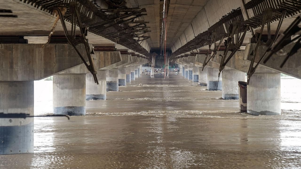 Swollen Yamuna river flows under a bridge, in New Delhi. Credit: PTI Photo