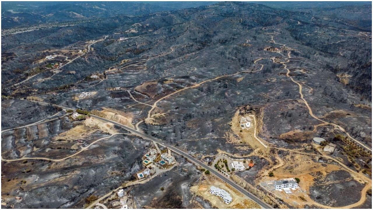 An aerial view of houses among burned land, as a wildfire burns on the island of Rhodes, Greece July 27, 2023. Credit: Reuters Photo