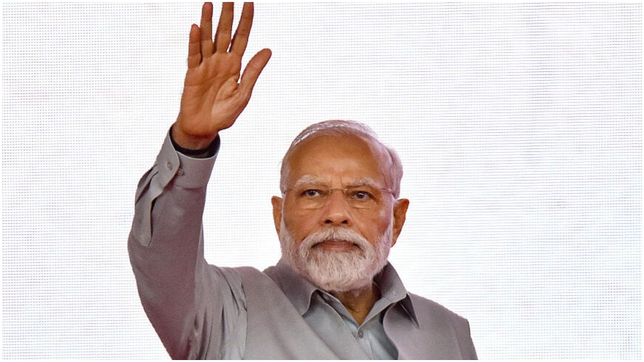 Rajkot: Prime Minister Narendra Modi waves during a public meeting after inaugurating Rajkot International Airport, in Rajkot, Thursday, July 27, 2023. Credit: PTI Photo