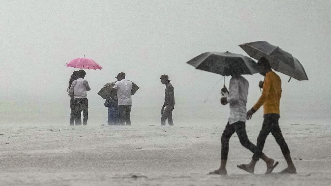 People during monsoon rains, in Mumbai, Wednesday, July 26, 2023. Credit: PTI Photo