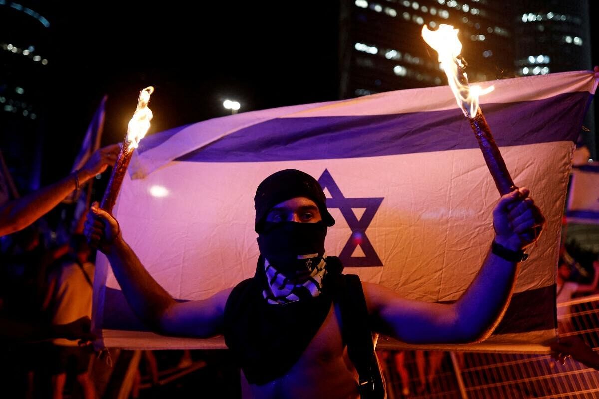 A protester takes part in a demonstration following a parliament vote on a contested bill that limits Supreme Court powers to void some government decisions, in Tel Aviv, Israel. Credit: Reuters Photo