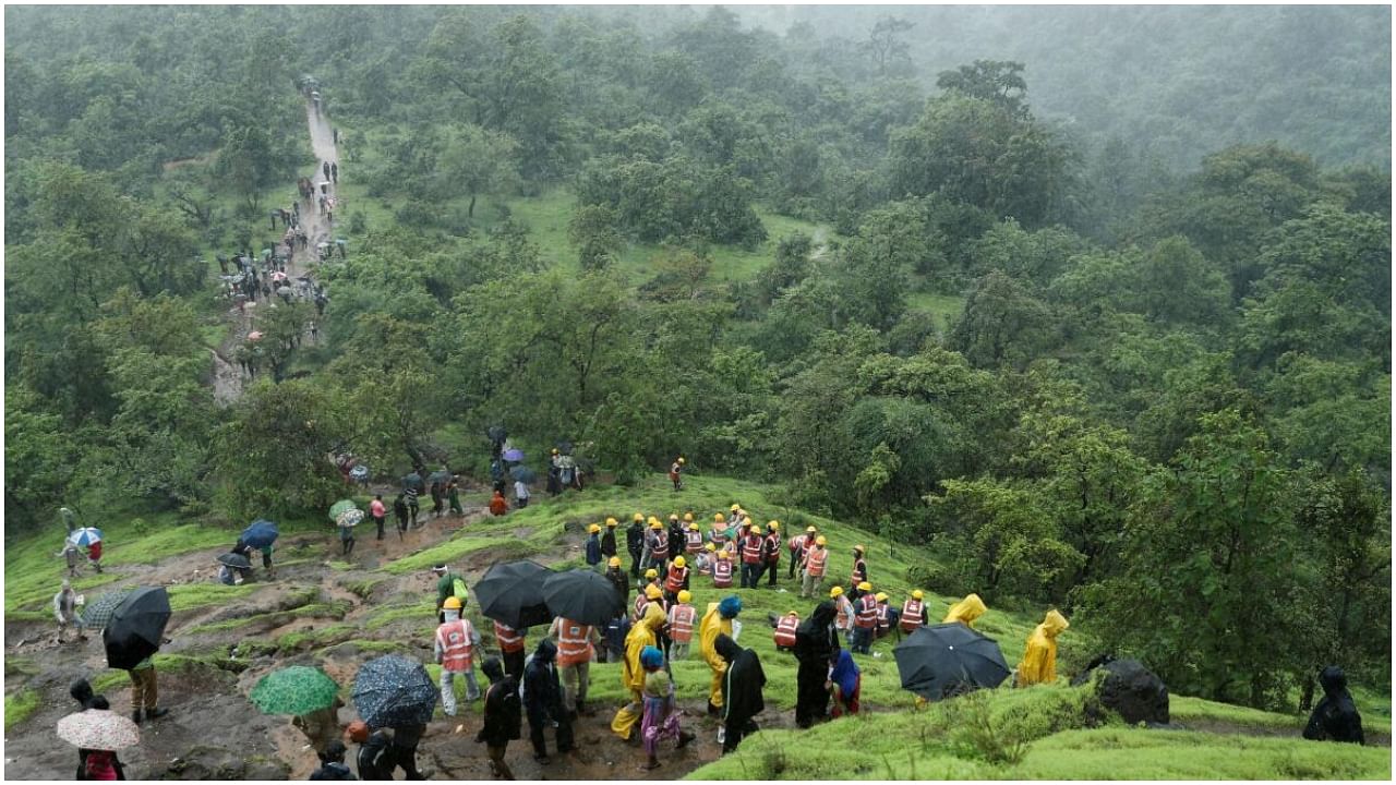 National Disaster Response Force (NDRF) personnel and other volunteers climb up a mountain to reach the site of a landslide at a village in Raigad, in the western state of Maharashtra, India July 20, 2023. Credit: Reuters Photo