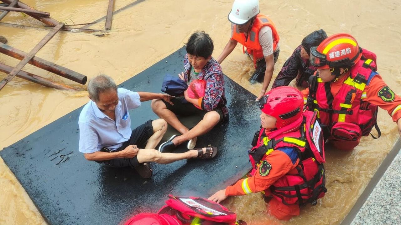 Firefighters evacuate residents stranded by floodwaters after Typhoon Doksuri made landfall in Quanzhou, Fujian province, China July 28, 2023. Credit: Reuters Photo