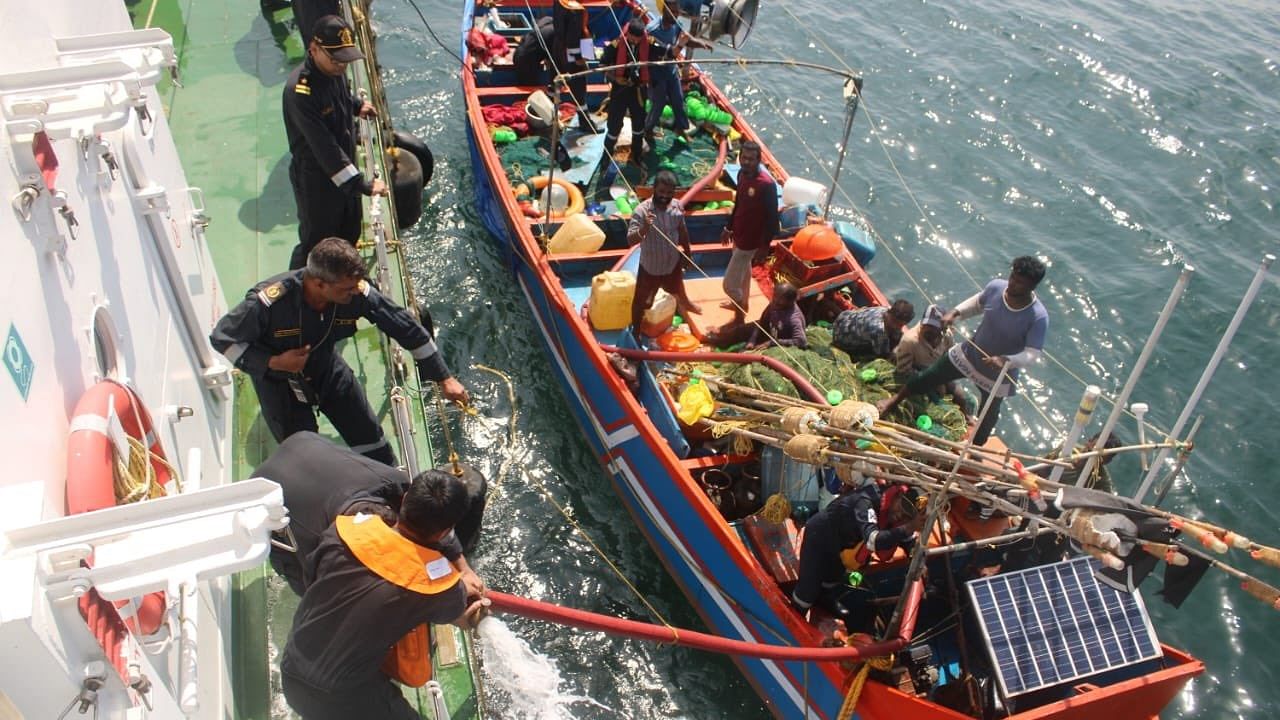 Indian Coast Guard officials rescuing stranded fishermen from the boat. Credit: X/@IndiaCoastGuard