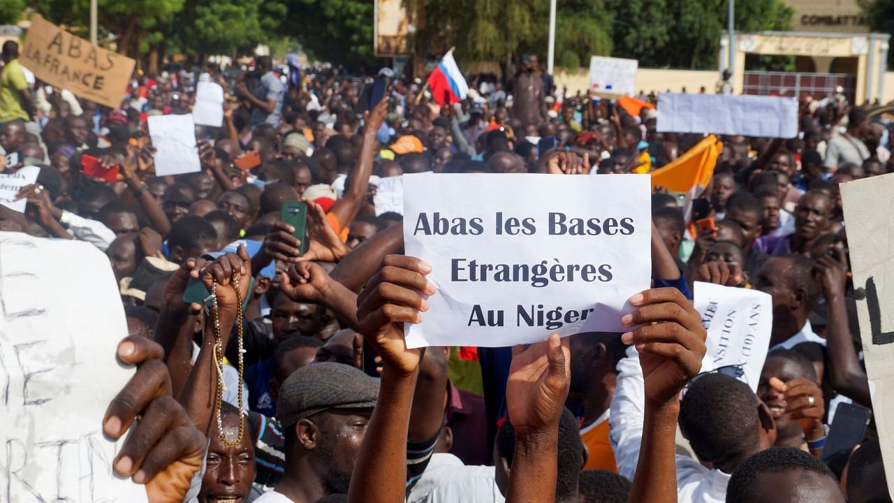 Demonstrators gather in support of the putschist soldiers in the capital Niamey, Niger July 30, 2023. Sign reads 'Down with foreign bases in Niger'. Credit: Reuters Photo