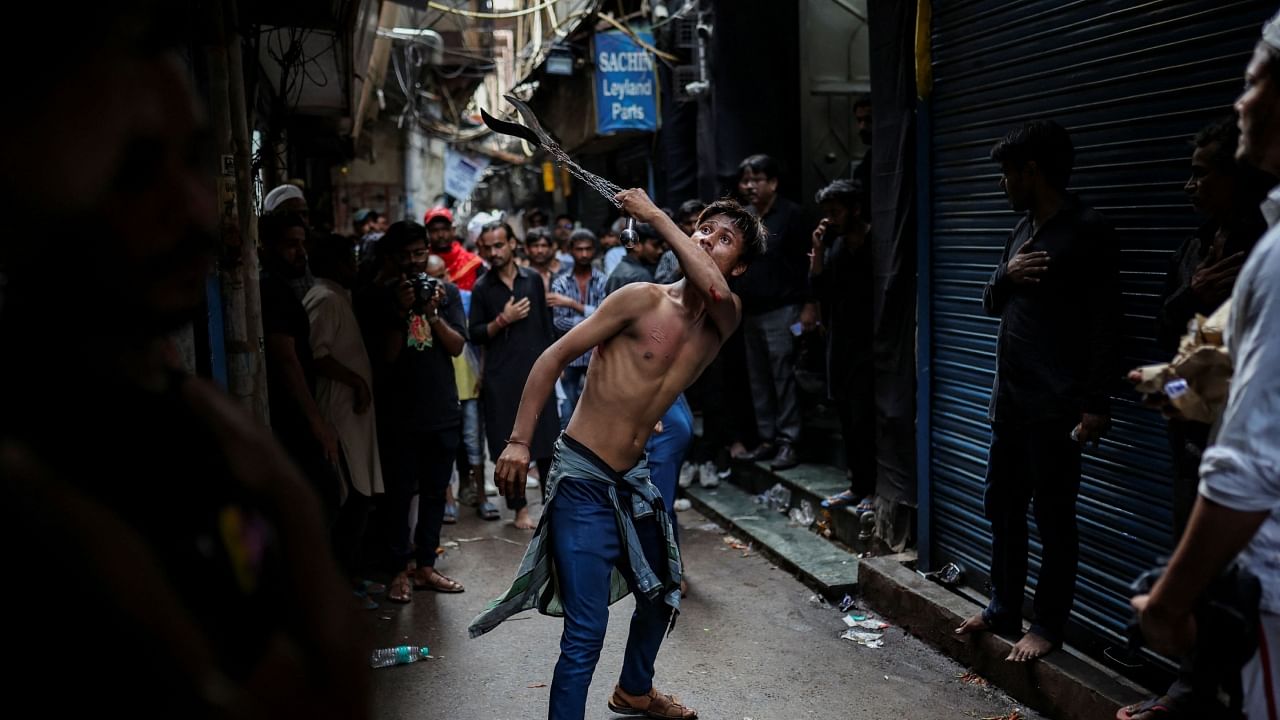 A Shi'ite Muslim flagellates himself during a Muharram procession marking Ashura, in the old quarters of Delhi, July 29 2023. Credit: Reuters Photo