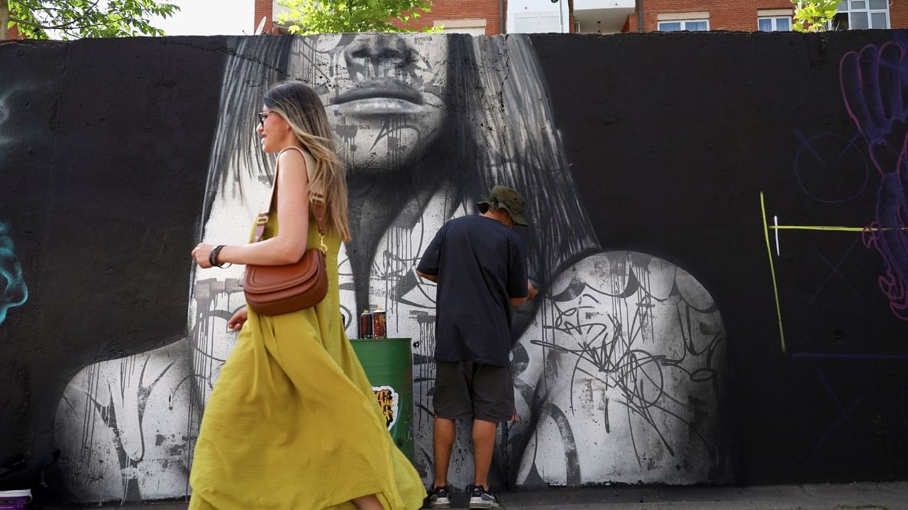 Swalt, a graffiti artist from Switzerland, paints a mural as part of the Meeting of Styles graffiti festival in Kosovo's capital Pristina, Kosovo July 29, 2023. Credit: Reuters Photo