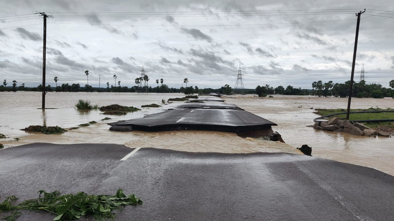 A partially damaged road is seen submerged in the floodwaters of the swollen Godavari River, in Bhupalpally district. Credit: PTI Photo