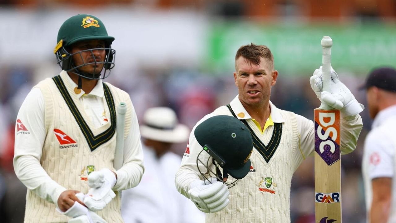 Australia's David Warner and Usman Khawaja talk as they leave the field for lunch on the fourth day of the test. Credit: Reuters Photo